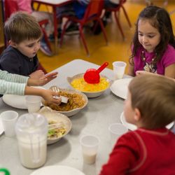 Kids eating lunch around table