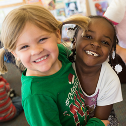 two girls hugging with pigtails